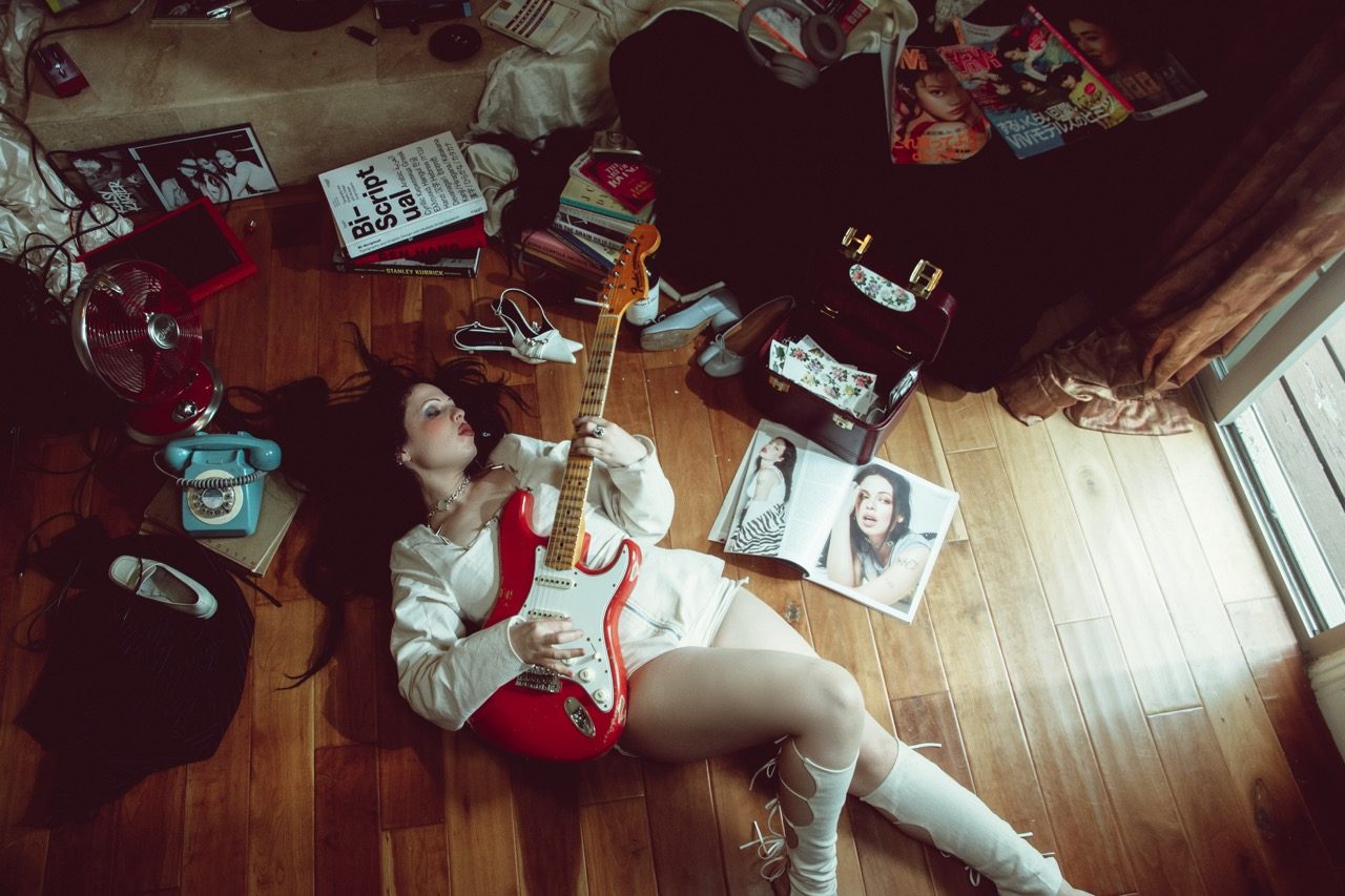 Trompe L'oeil Campaign | Fuoco, cover, overhead shot with red guitar on the floor