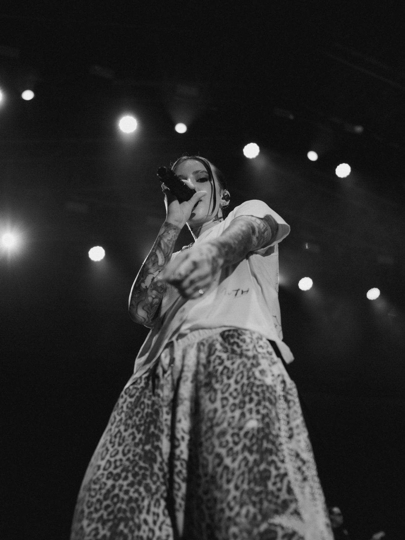 Young Miko performing, leopard-print trousers, low angle